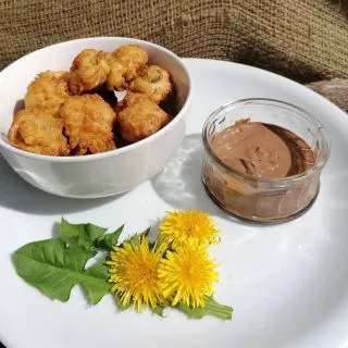 Battered Dandelion Blossoms

This is a recipe I cook sometimes with either a sweet or savoury dip or sauce.

Sometimes with honey, chocolate sauce, yogurt, cream or ice cream.
Salt pepper, chilli, sweetchilli sauce, garlic mayo dip or as a side to a Chinese stir fry.

They are tasty crunchy nuggets full of goodness!!!

Ingredients
1 cup self raising flour
1 cup milk or sparkling water
1 free range egg
A pinch of salt and pepper if doing a savoury recipe.

Method
Mix all the above with a whisk.
Heat up veg or sunflower.
After picking the large open flower heads, dip them into flour then submerge in the batter mix.
Carefully drop into the hot oil and cook until golden brown for approx 2 - 3 mins.
Drain from the oil and place on some kitchen roll so the excess fat is absorbed.
Enjoy!!!
#Forageuk #Foraging #Wildfood #Foriginginworcestershire #Wildfoodwalks #Forageyourfood #Organicfood #Dandelions #rewild #Reconnectwithnature #eatgreen #Plantbased #Pesticidefree #plasticfree #zerowaste